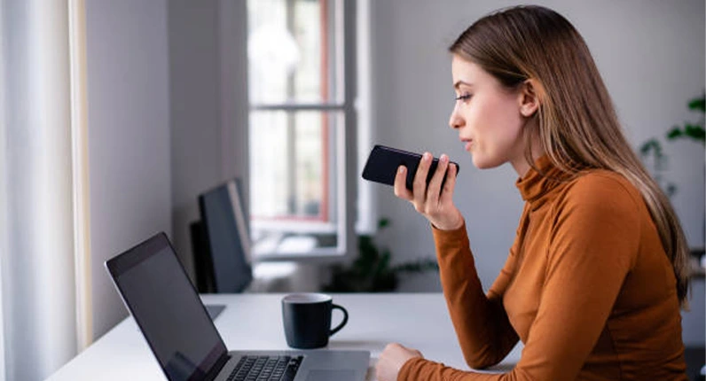 Woman giving a voice command to her phone for a search | Pepi Digital